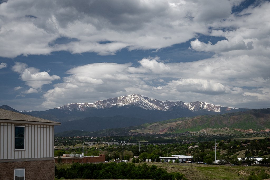 a view of the snow covered mountains in the distance from a house
