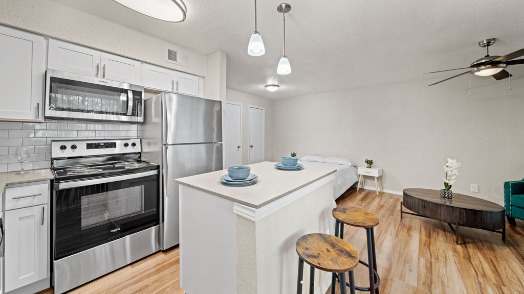 a kitchen with an island and two stools