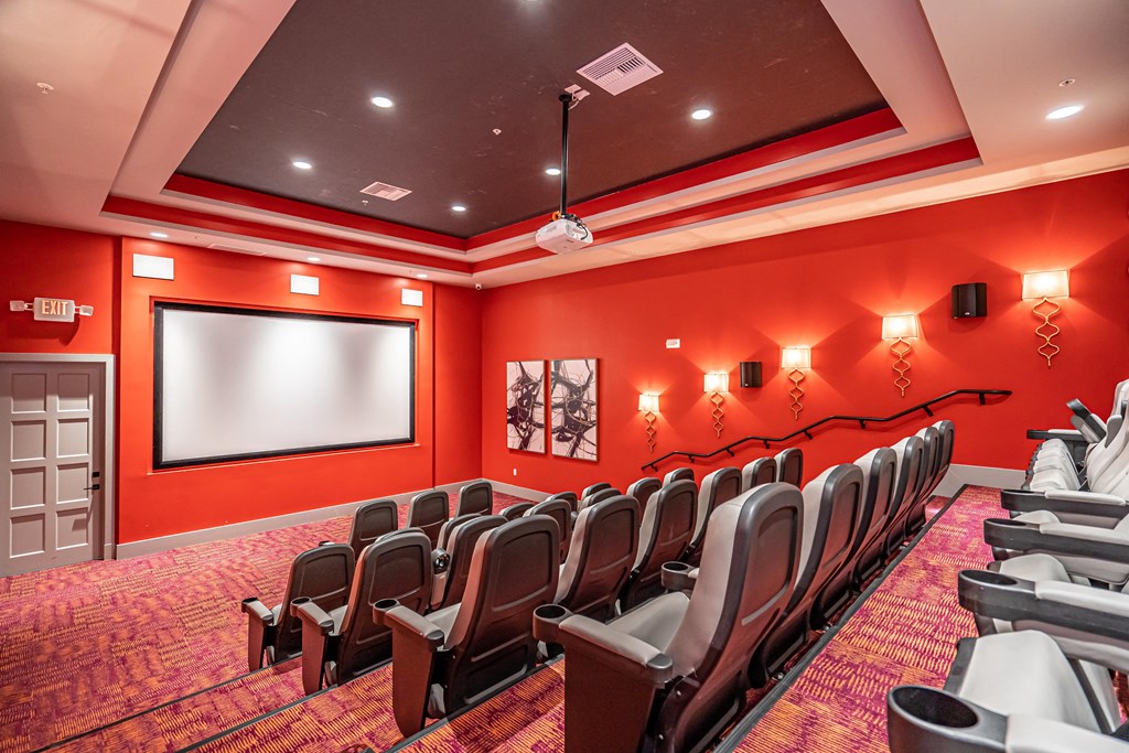 a room with a projector screen and chairs