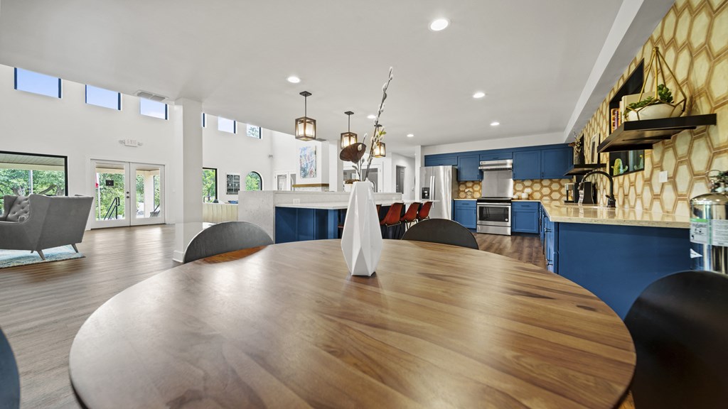 a large dining table with a view of the kitchen and living room