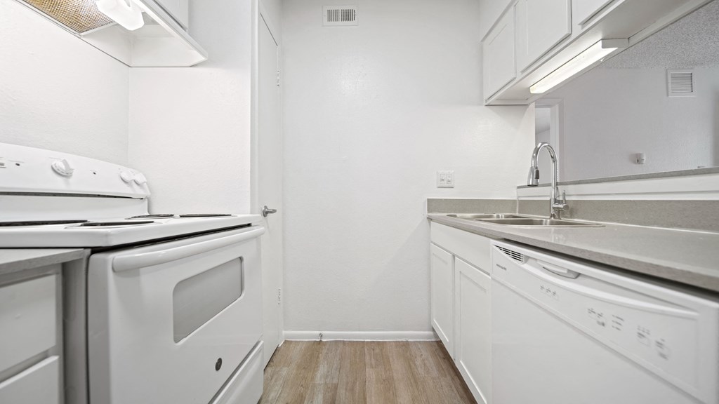 a kitchen with white cabinetry and white appliances