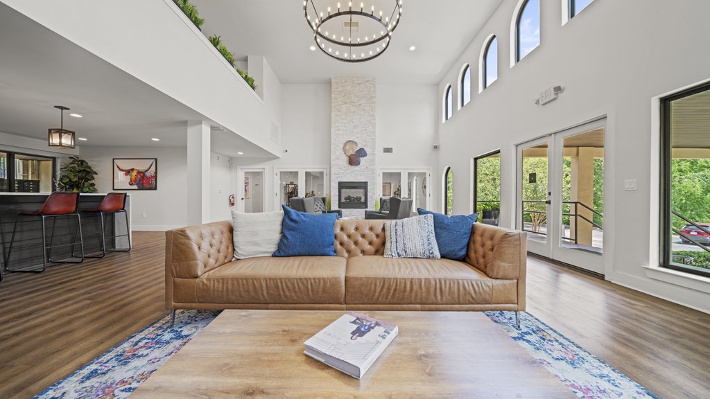 a living room with a couch and coffee table in front of a fireplace