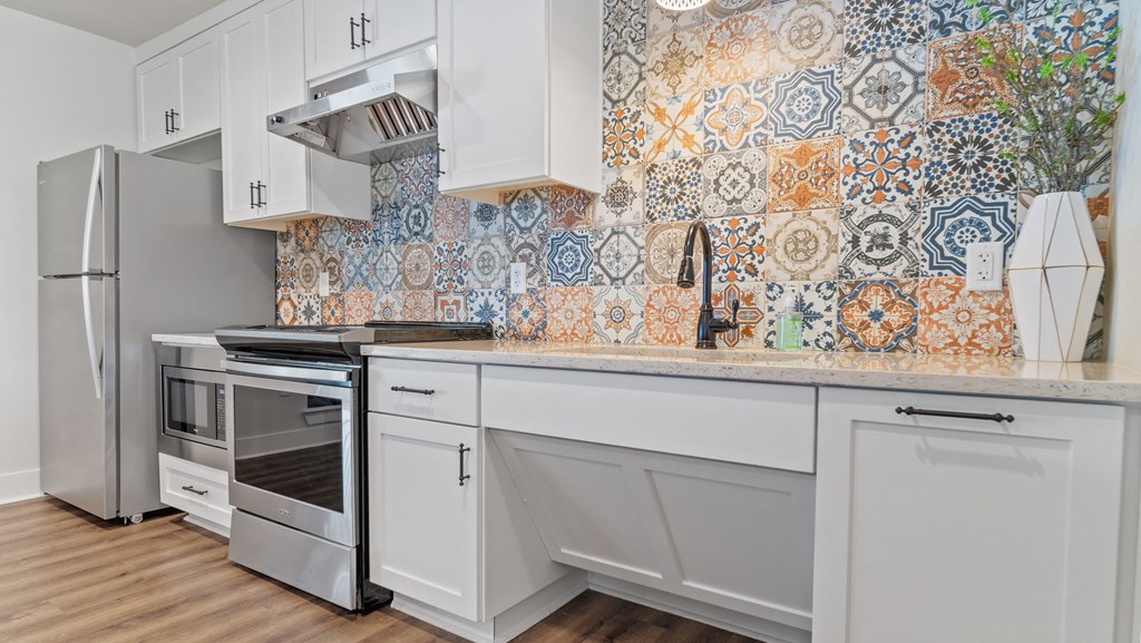 a kitchen with white cabinets and white appliances