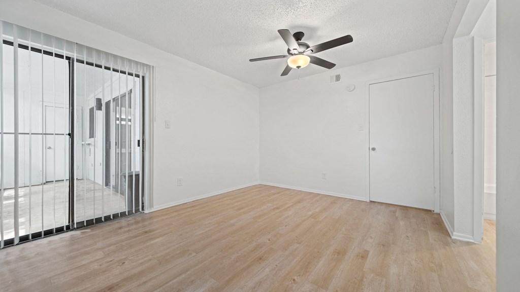 a bedroom with hardwood floors and a ceiling fan