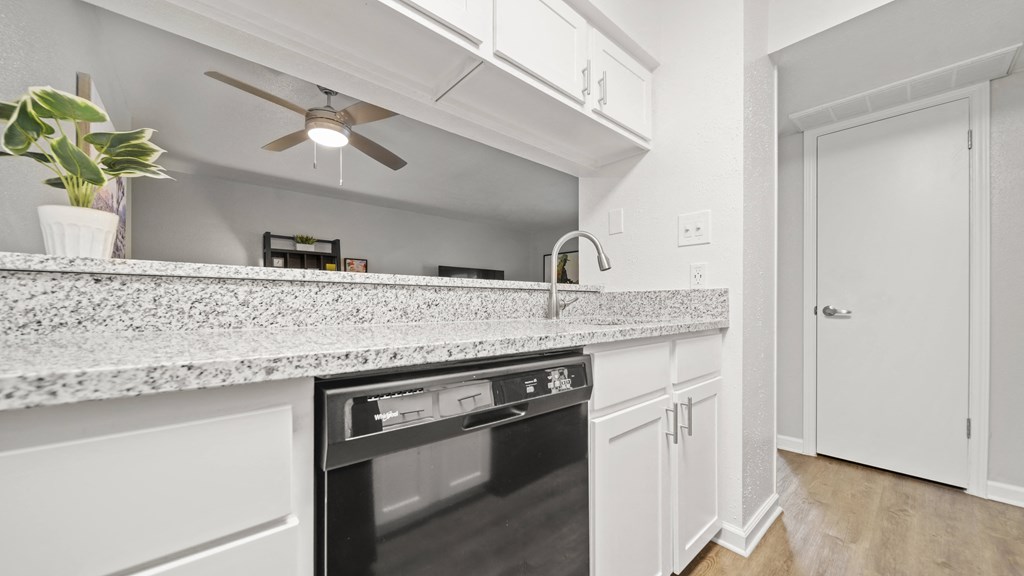 a kitchen with an island and a ceiling fan