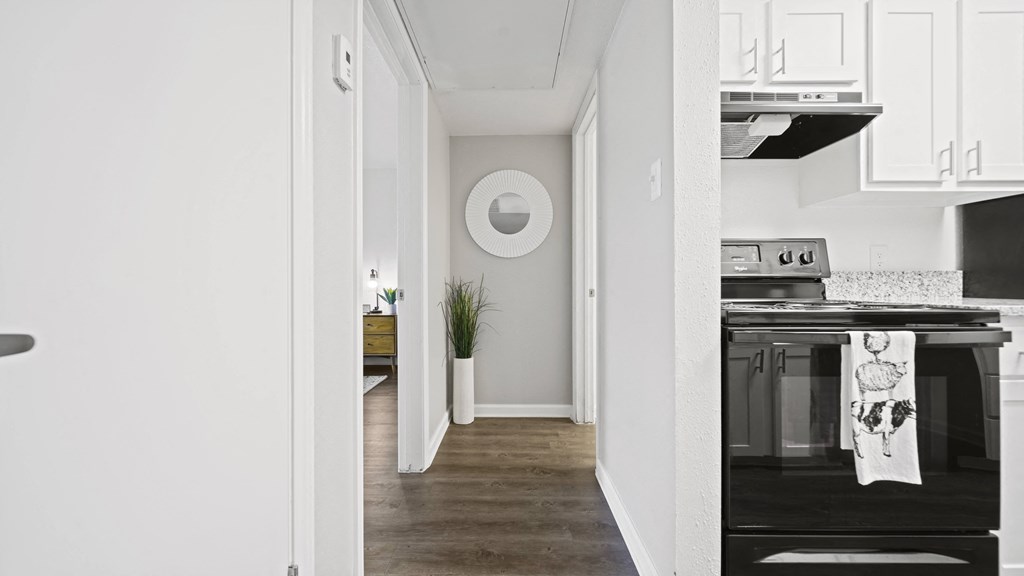 a kitchen in a 555 waverly unit with white cabinets and a black stove and oven