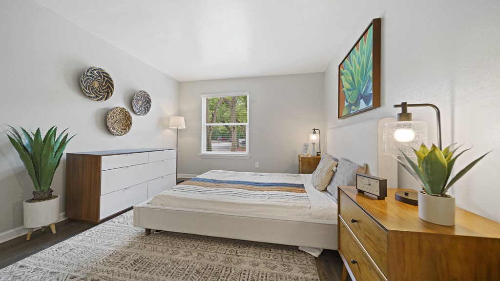 a bedroom with a bed and dresser