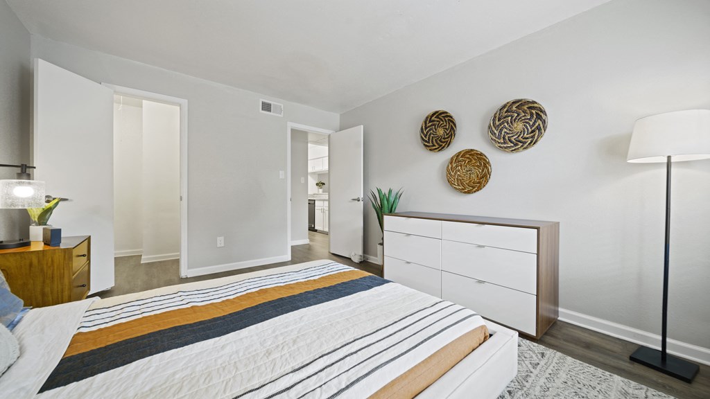 a bedroom with a bed and a dresser