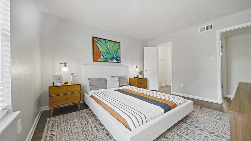 a bedroom with a bed and two night stands