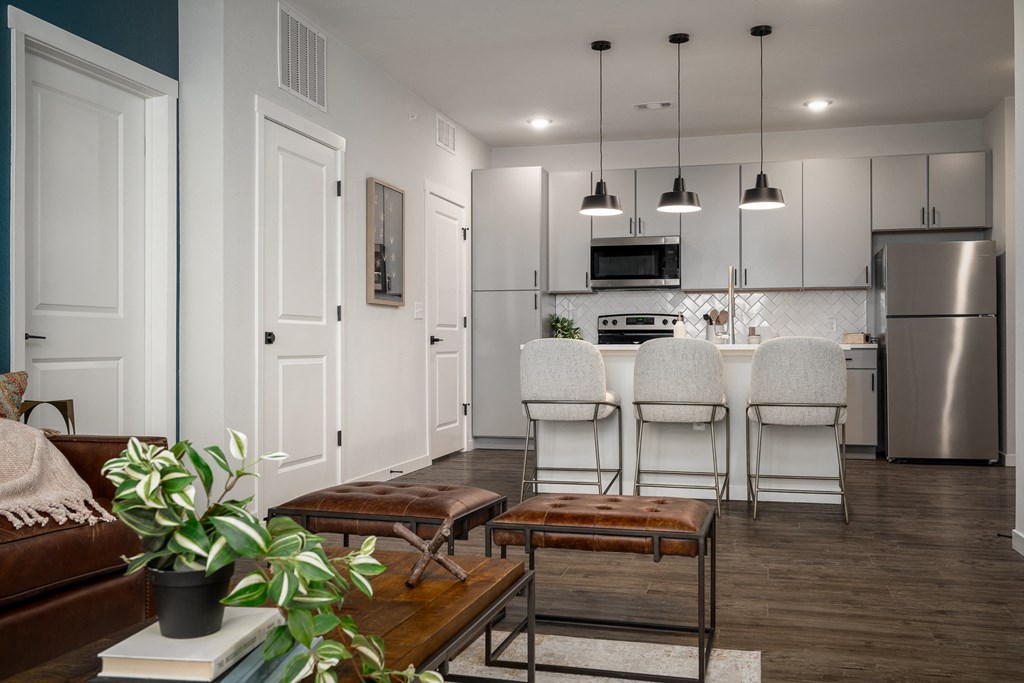 an open kitchen and living room with a table and chairs