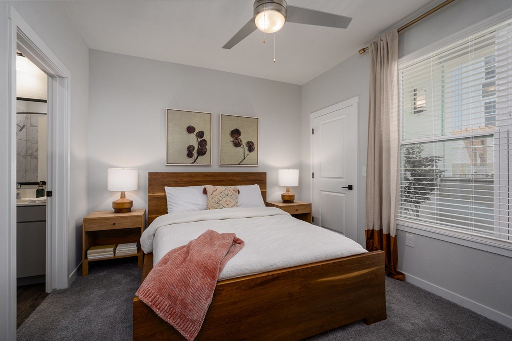 a bedroom with a large bed and a ceiling fan