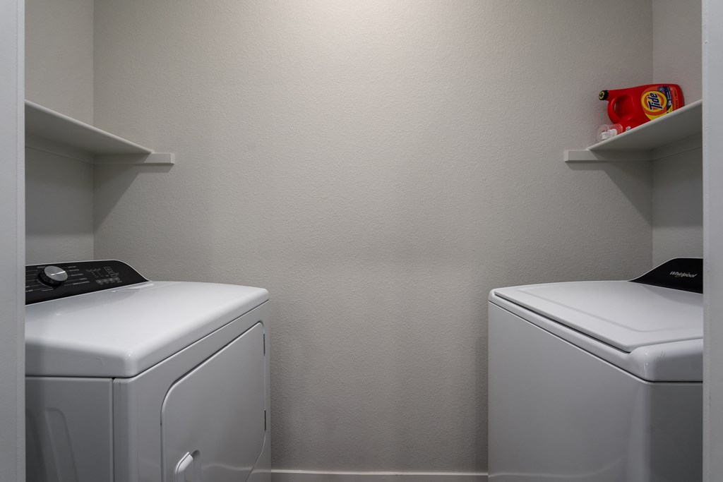 a small laundry room with two washes and a dryer