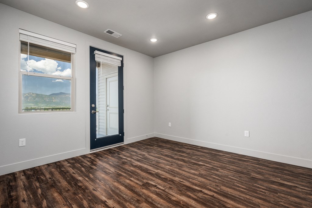 an empty room with a door and a window