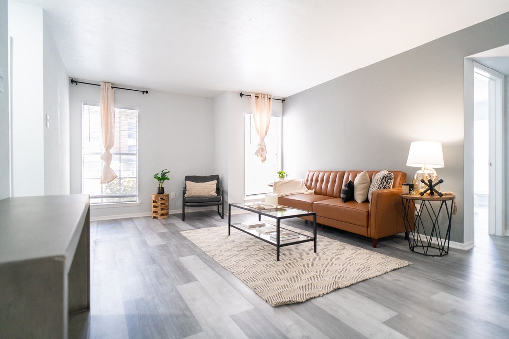 a living room with a leather couch and a coffee table