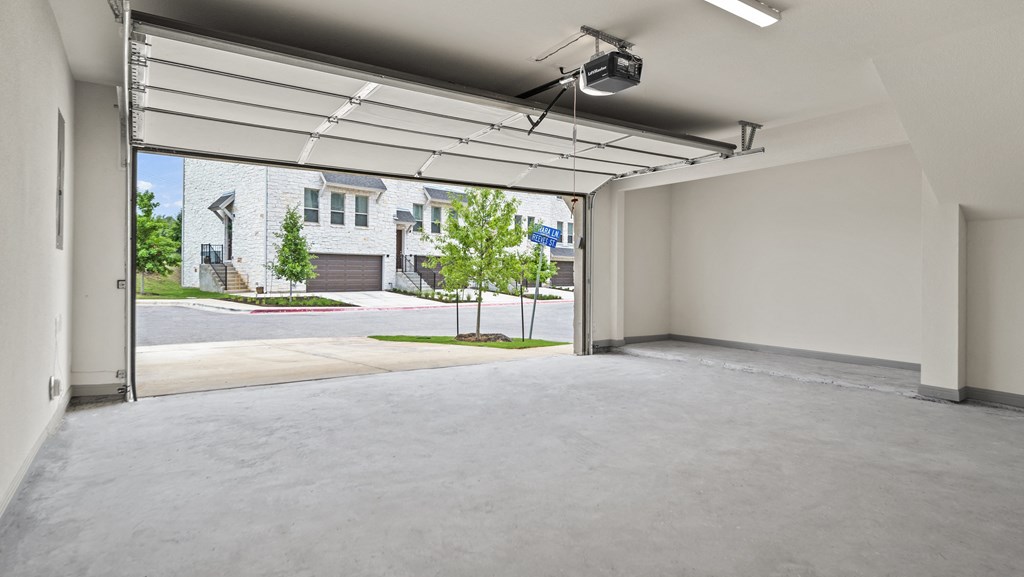 a large garage with sliding glass doors and a view of a brick building
