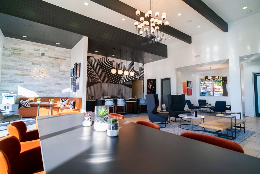the lobby of a hotel with a large table and chairs