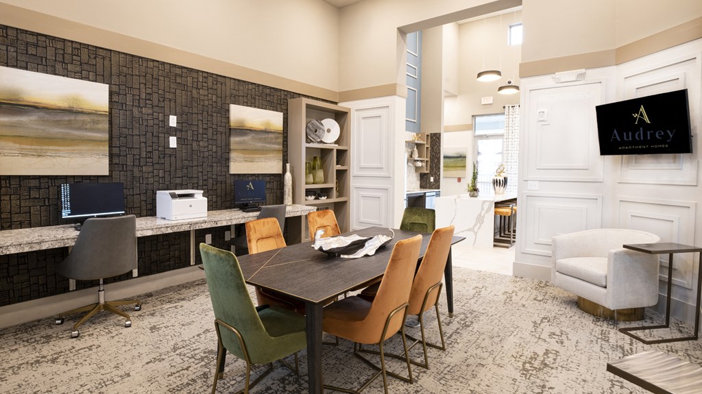 a dining room with a table and chairs and a kitchen with a desk and a