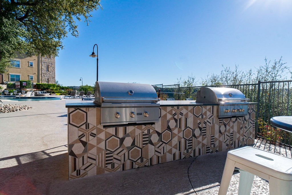 a grilling area with two grates and two bbqs