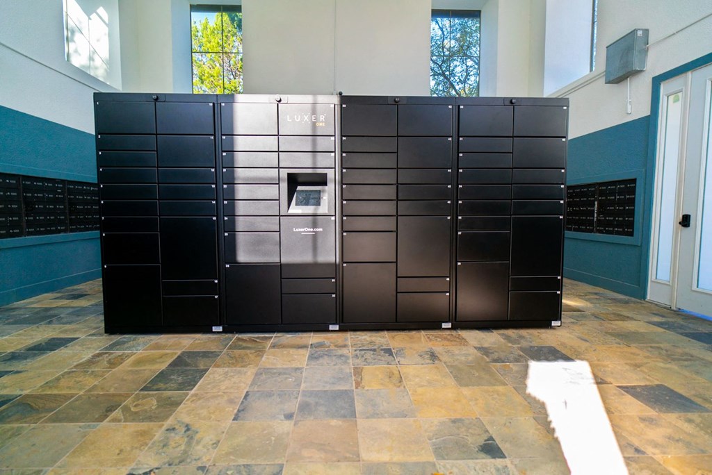 a set of black lockers in a room with a tile floor