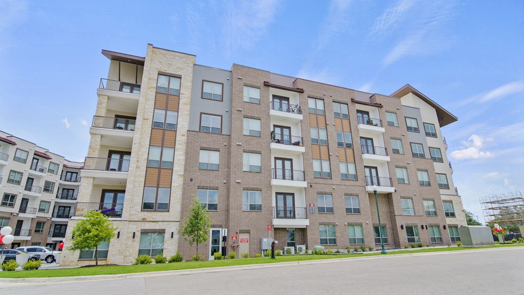 a large apartment building with a street in front of it