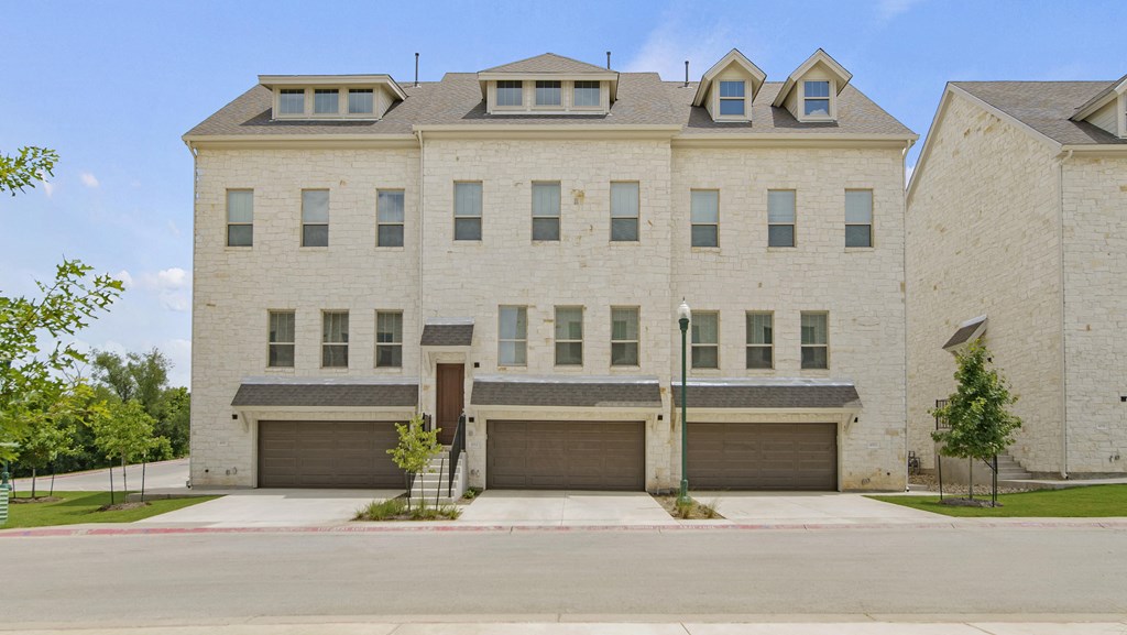 a large white brick building with two garages