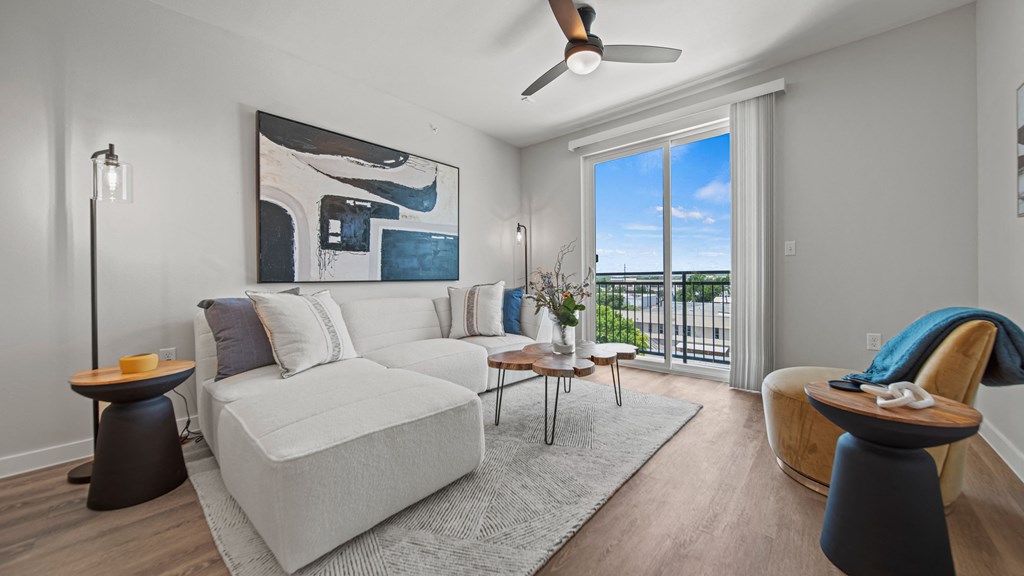 a living room with a white couch and a large sliding glass door