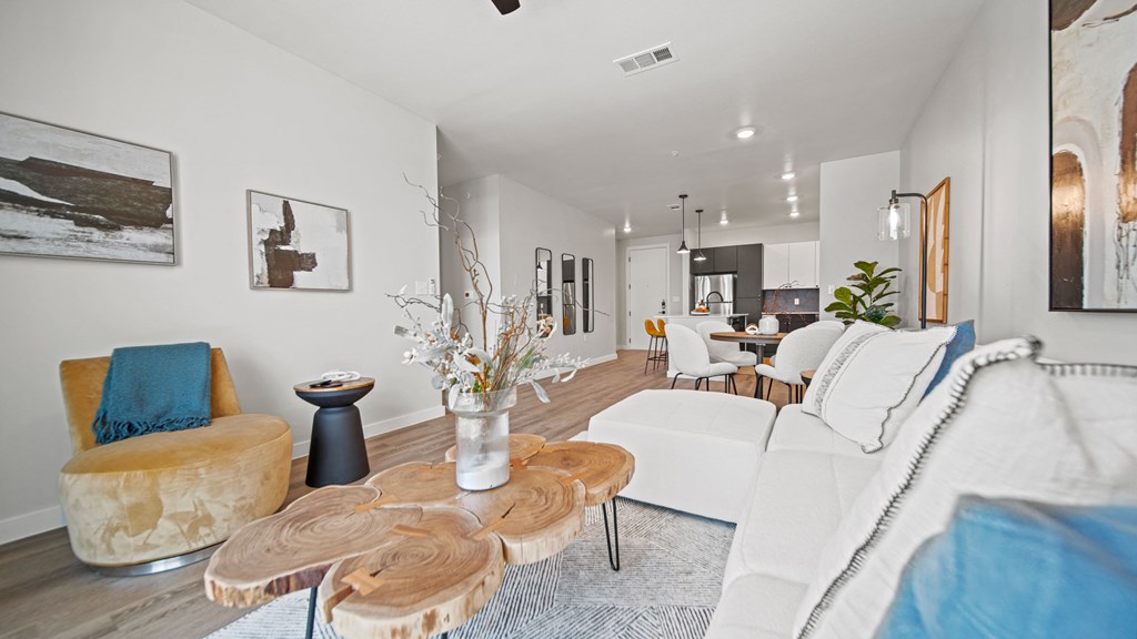 a living room with white walls and hardwood floors