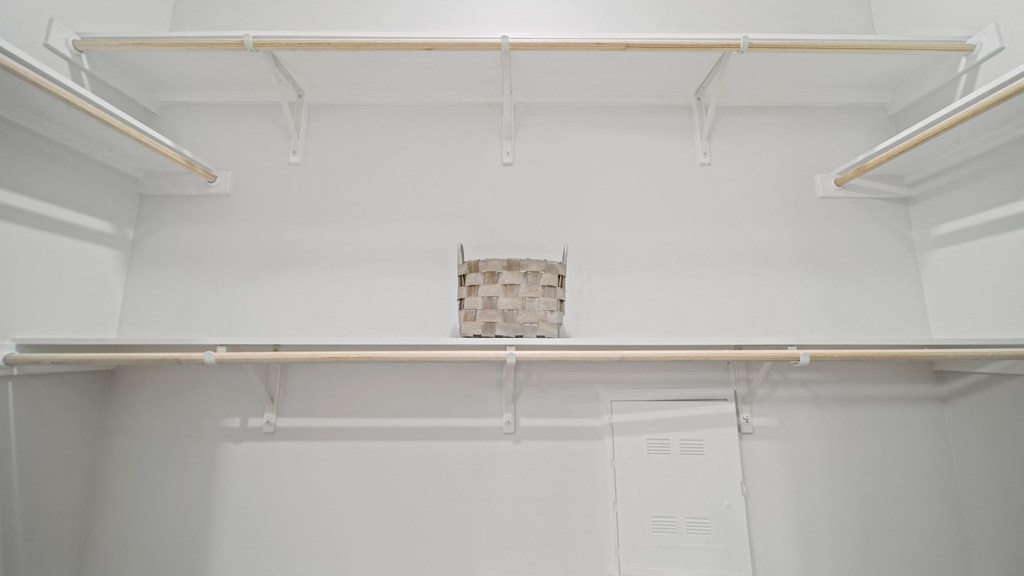 a room with white walls and a white ceiling with a brick wall in the middle