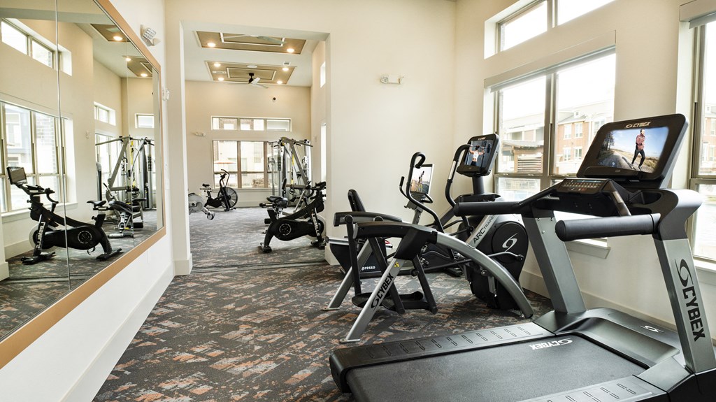 a gym with treadmills and other exercise equipment in a building