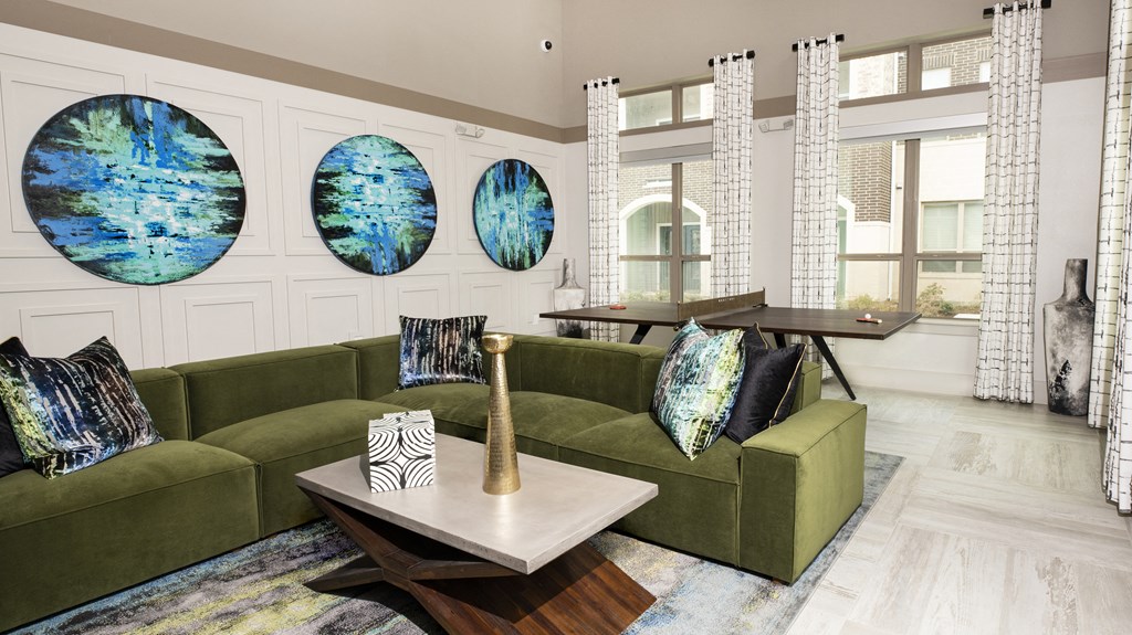 a living room with green couches and a coffee table