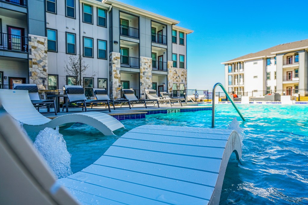 a swimming pool with a building in the background