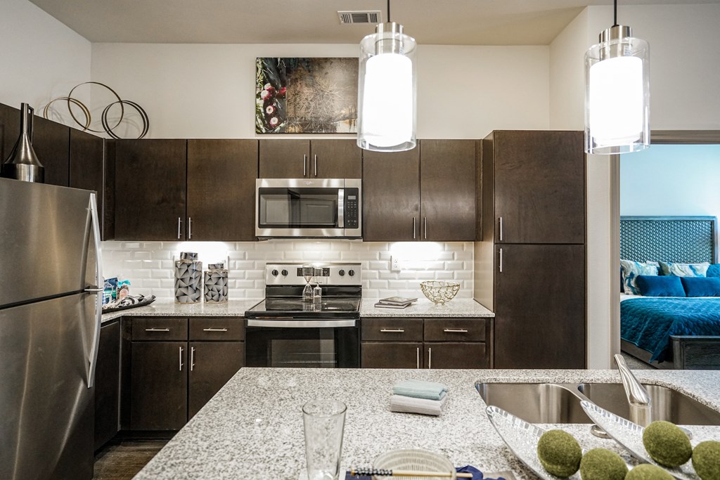 a modern kitchen with stainless steel appliances and granite counter tops