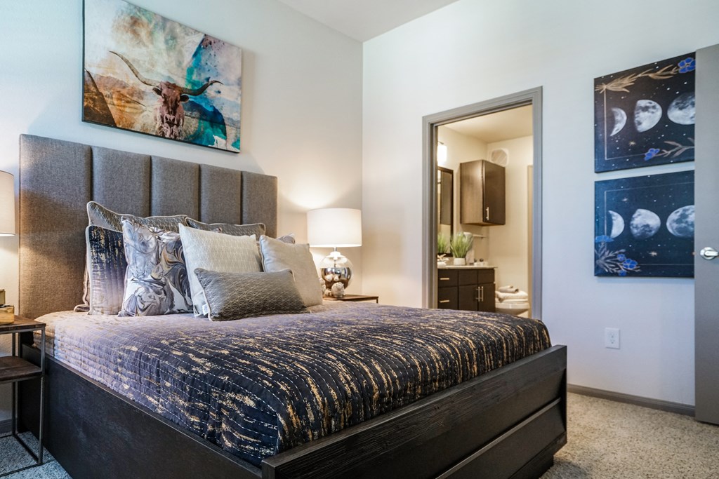 a bedroom with a bed and a door to a bathroom