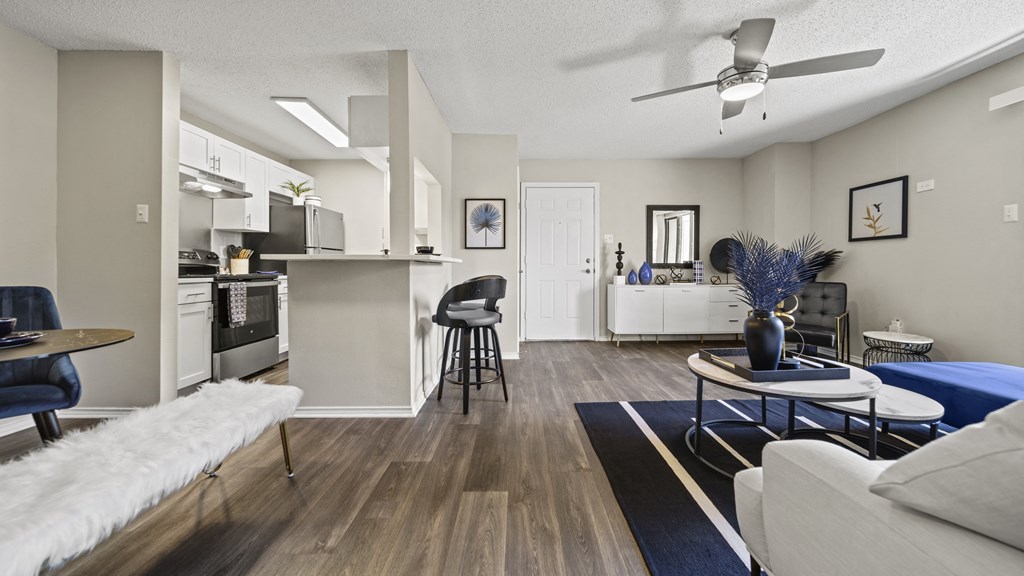 our apartments offer a living room with a couch a chair and a coffee table