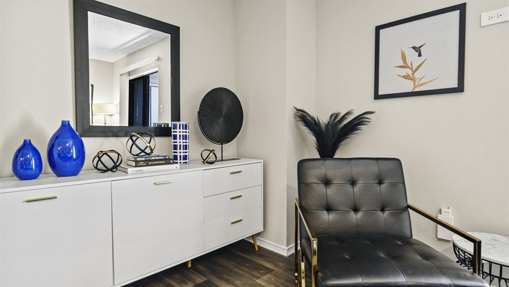 a room with a chair and a dresser