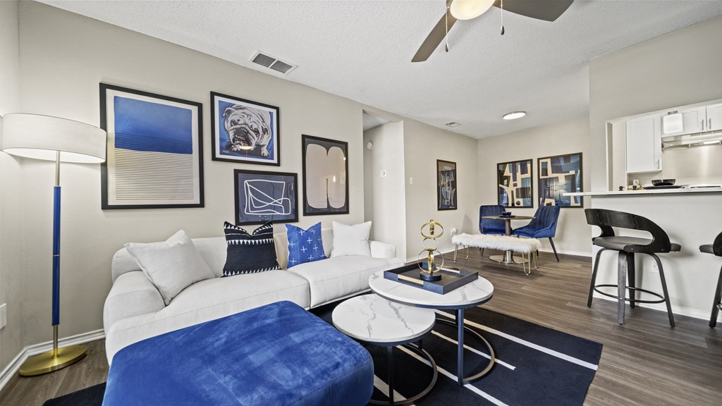 our apartments offer a living room with a couch a coffee table and a bar