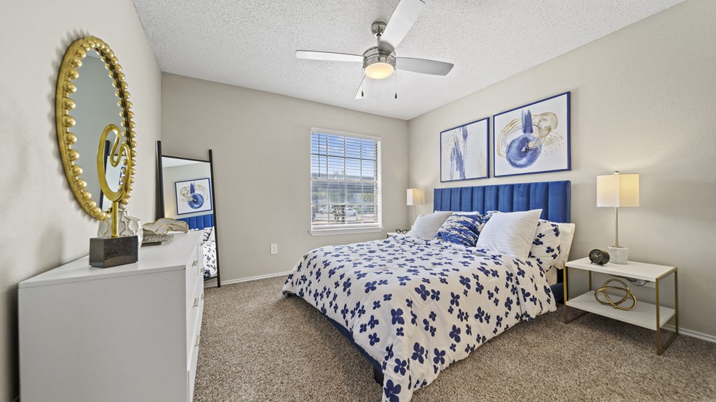 a bedroom with a bed and a ceiling fan