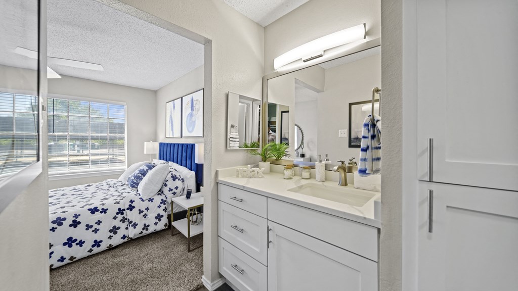 a bedroom with a bed and a mirror