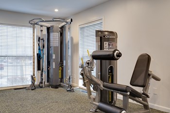 Fitness center featuring leg workout equipment and pullup bar. - Photo Gallery 15