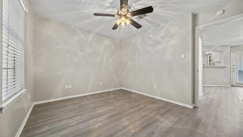 a bedroom with hardwood floors and a ceiling fan