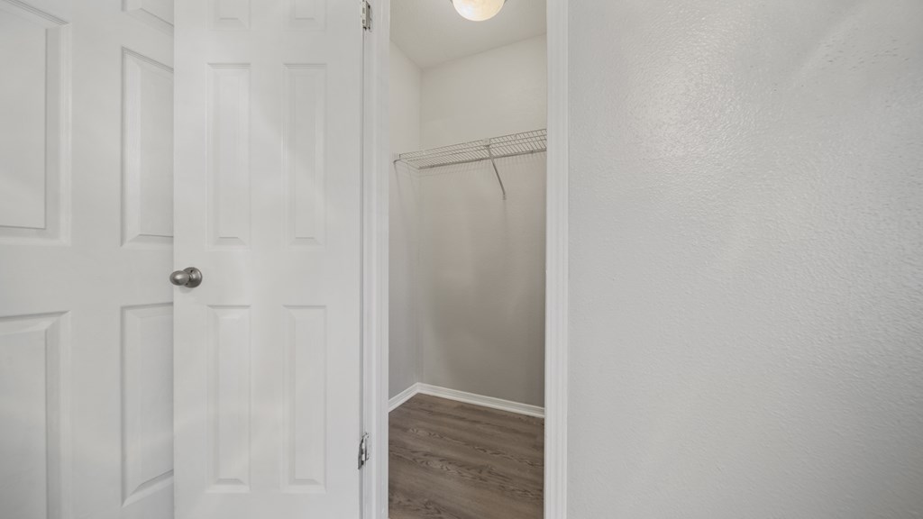 a bedroom with a white door and a white closet