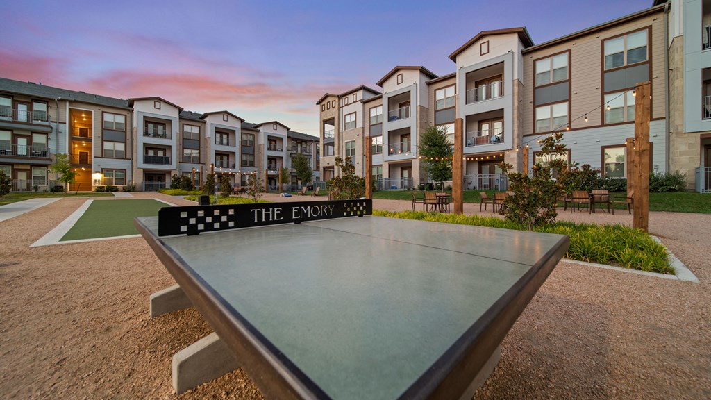 a ping pong table in front of an apartment complex