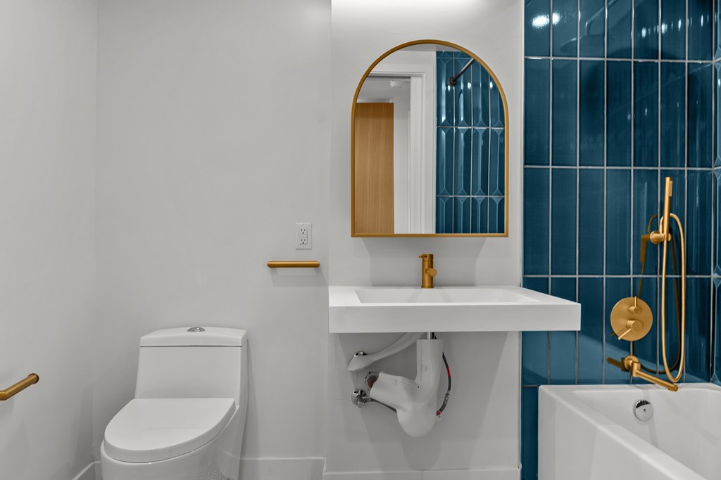 A white toilet sits next to a sink in a bathroom.