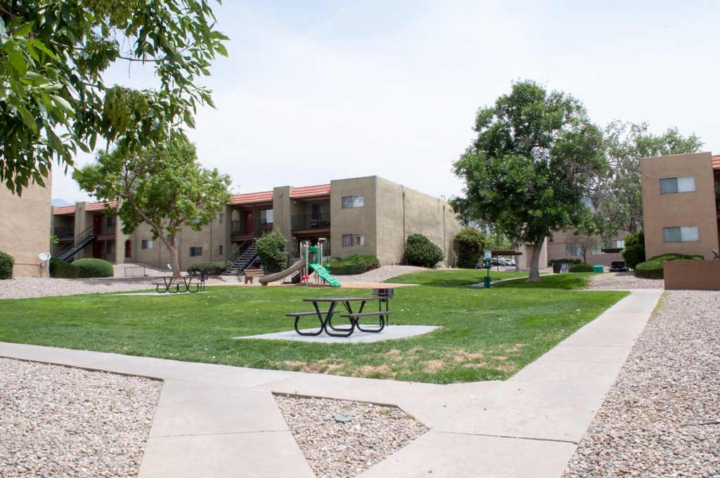 a park with a picnic table in front of a building