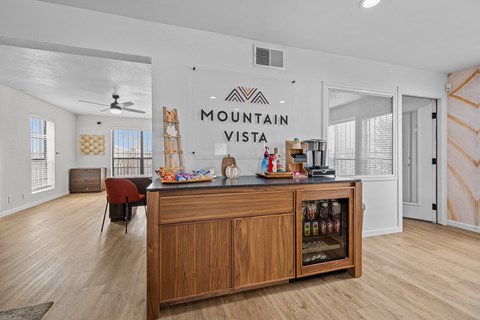 the living room with a bar and the mountain vista sign on the wall