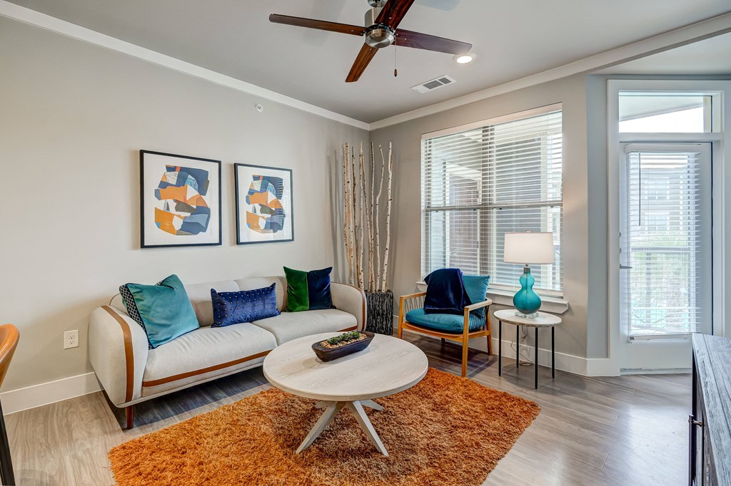 a living room with a ceiling fan and a couch
