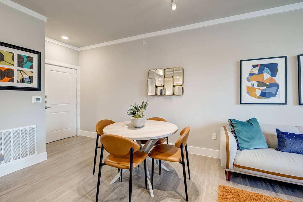 a dining area with a table and chairs and a couch