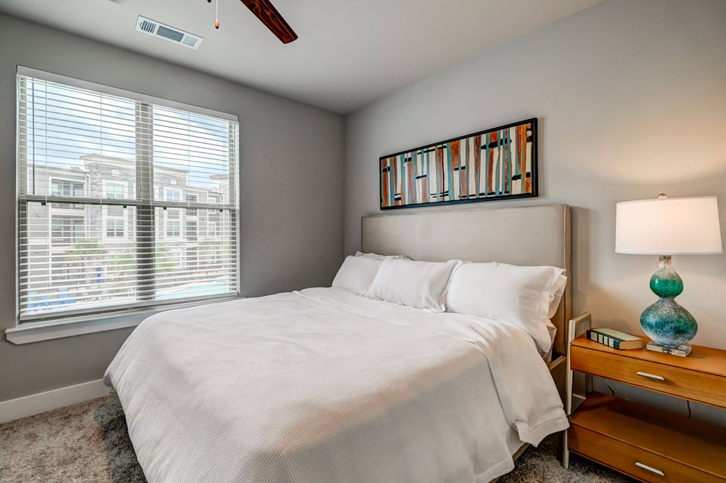 a bedroom with a large bed and a window