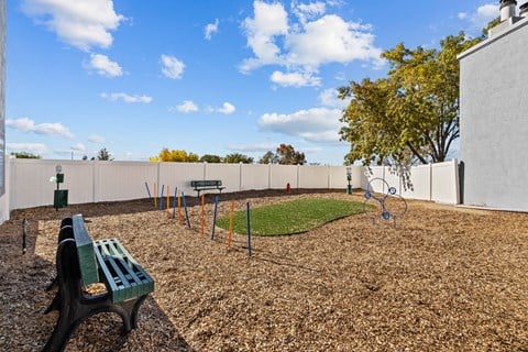 a park with a playground and a bench
