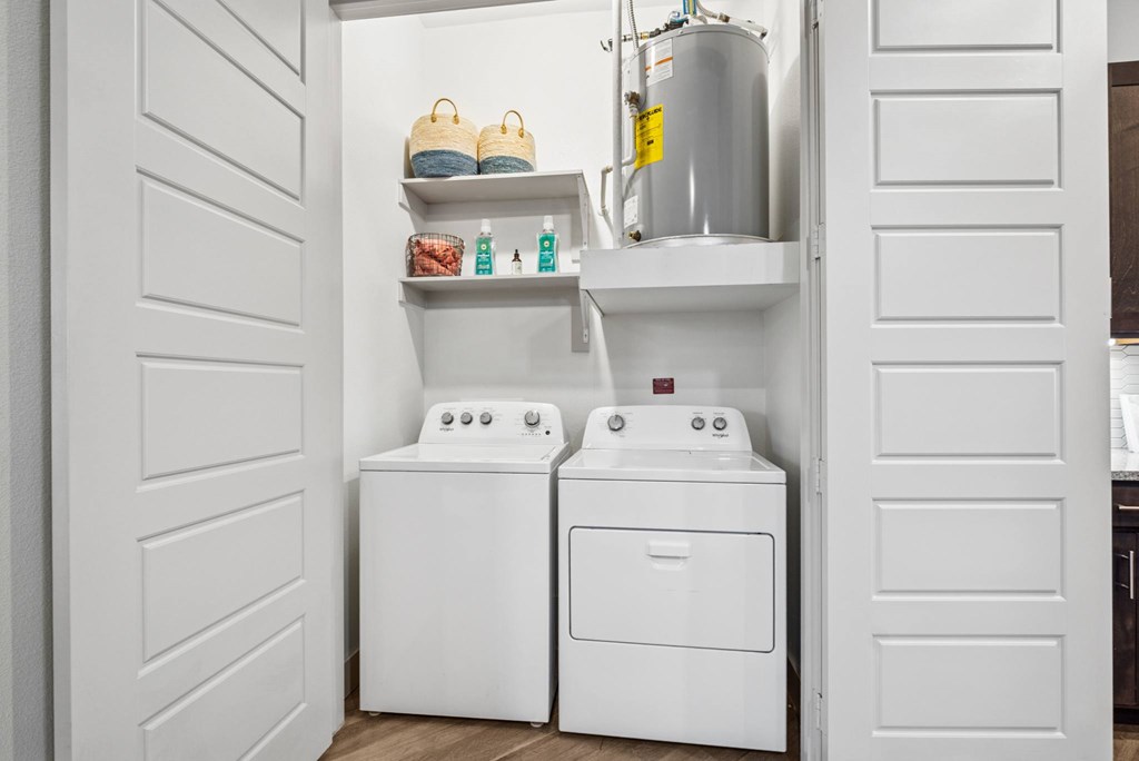 A white laundry room with a washer and dryer.